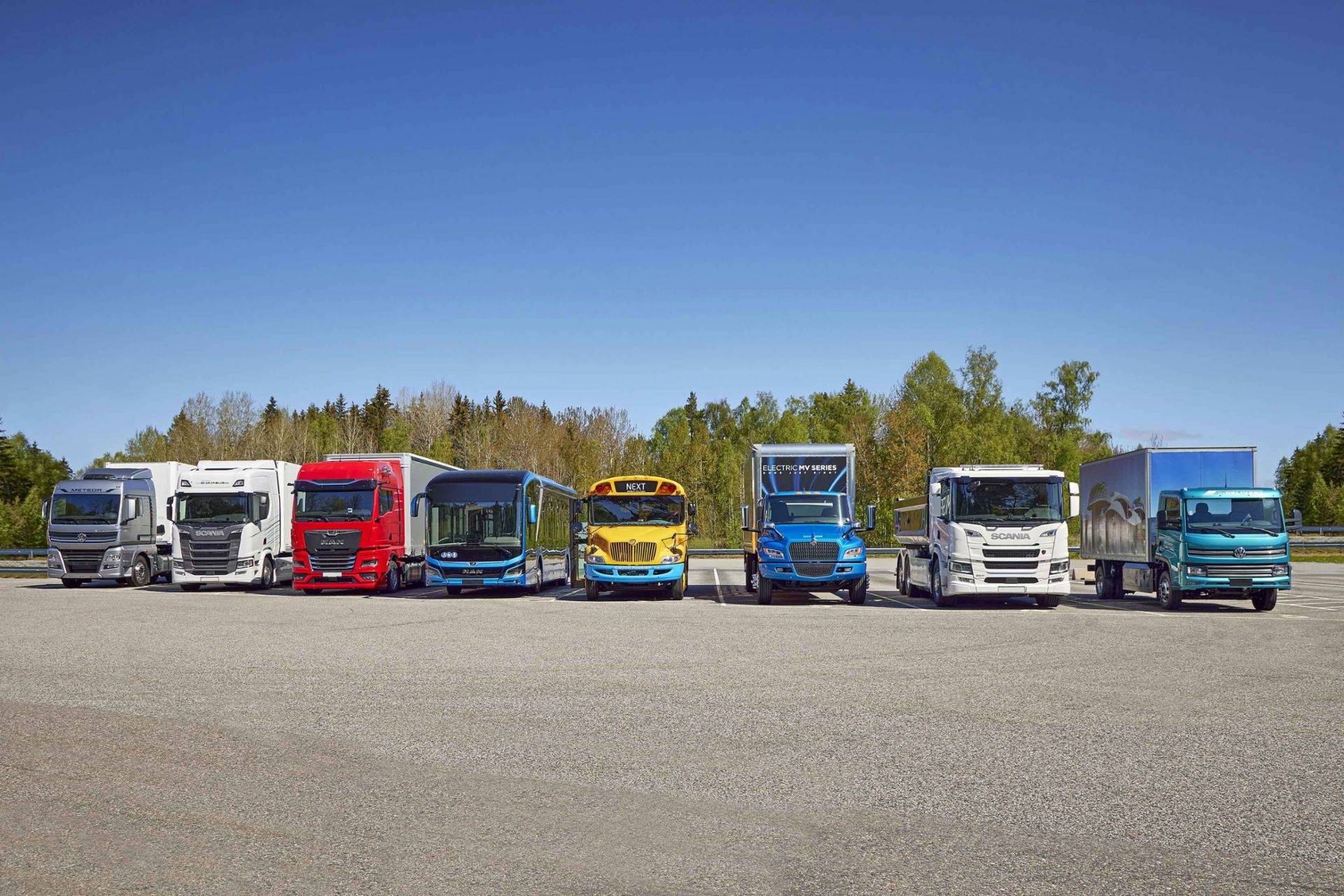 Eight trucks of different brand of TRATON side by side
