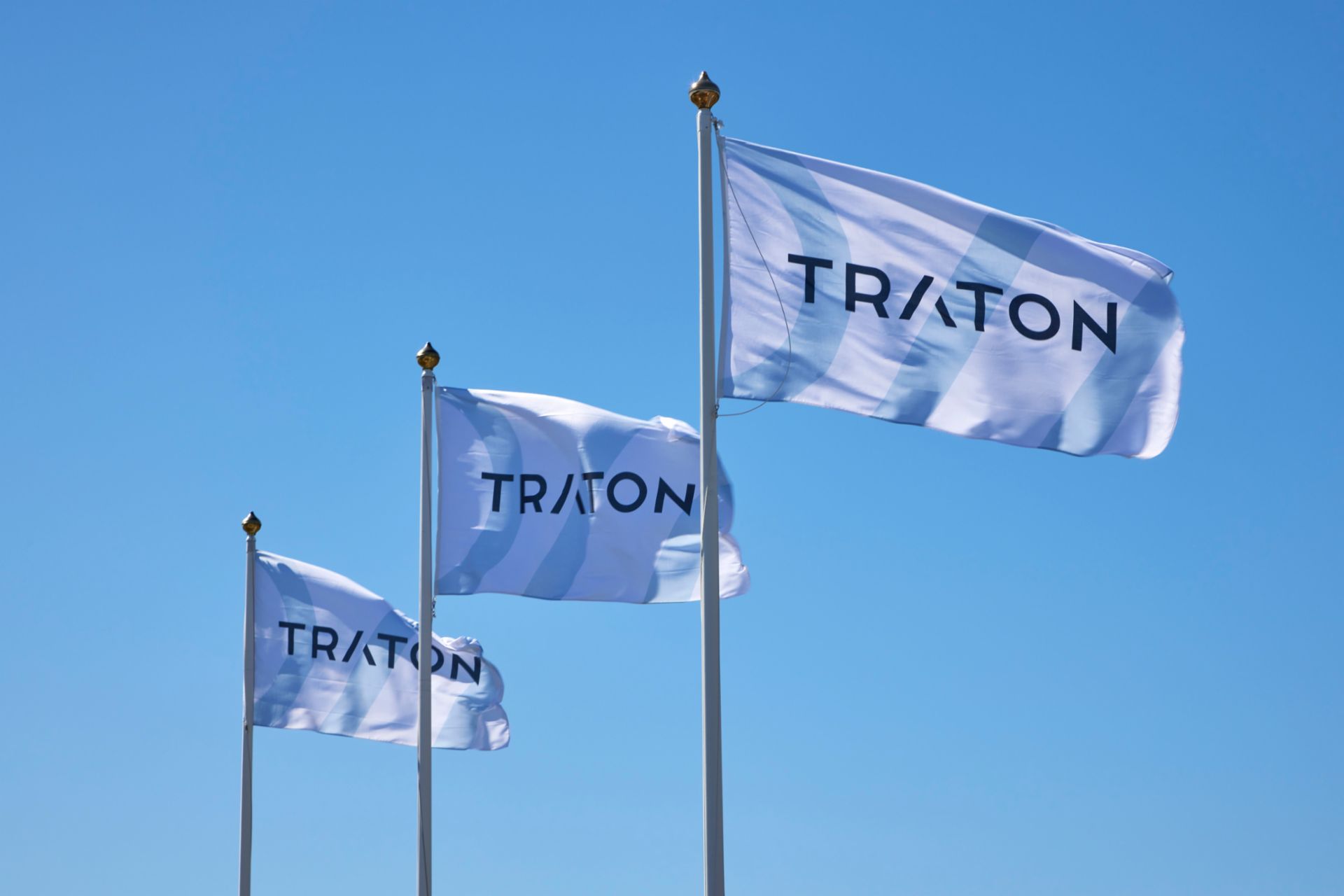 three company flags with the logo of TRATON