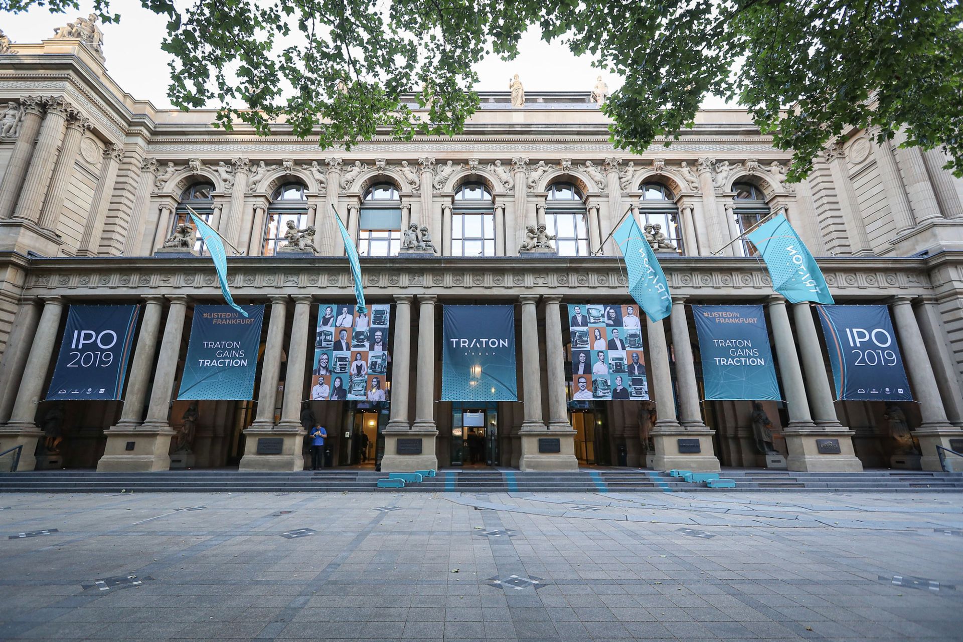Blue TRATON flags and banners on the facade of the German Stock Exchange
                 