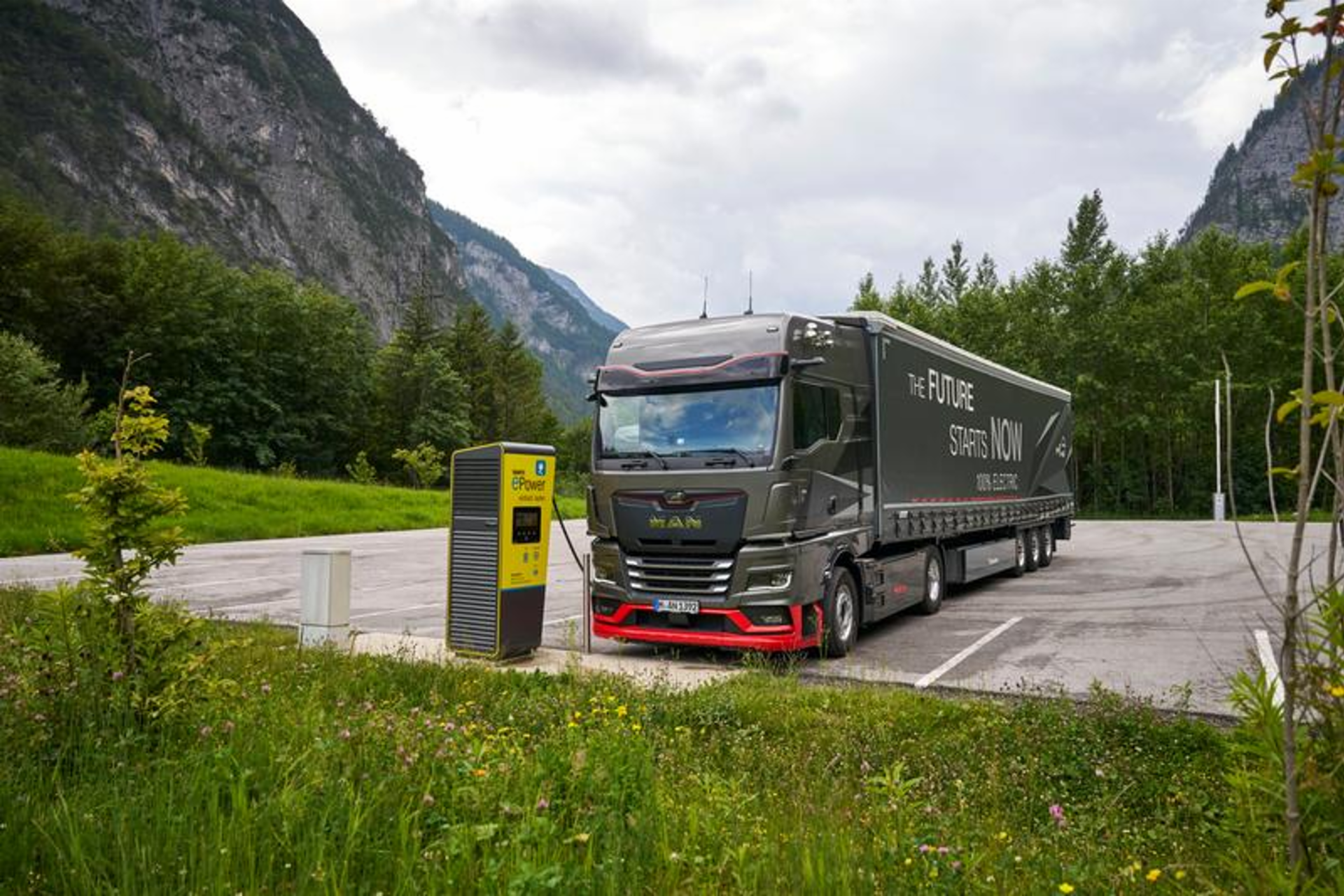 A MAN eTruck is currently being charged at a charging station in the mountains using megawatt charging.