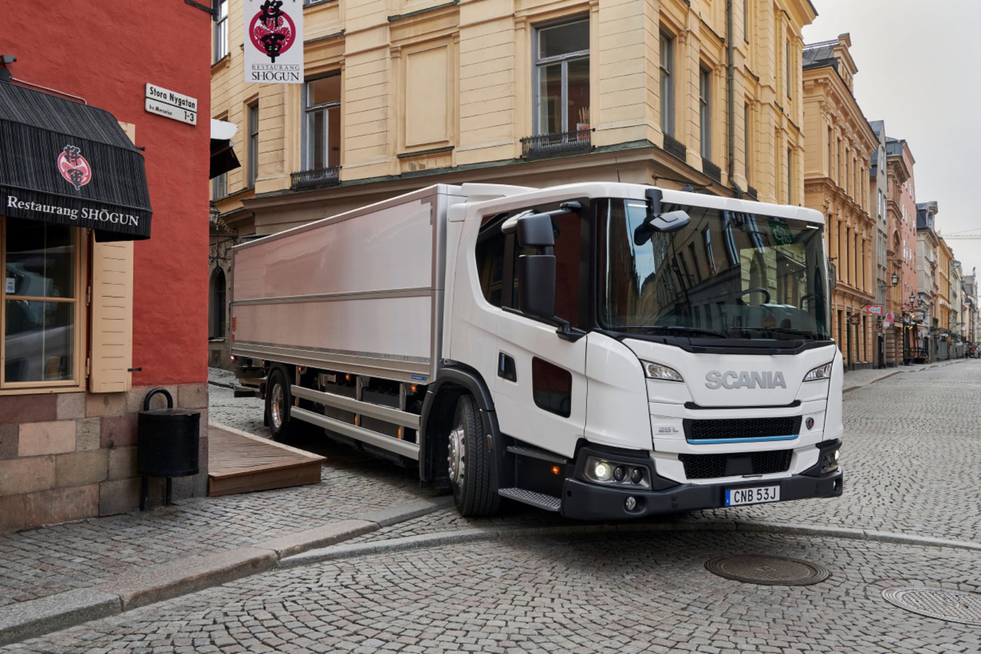 SCANIA truck drives in a small street in the old town of Stockholm